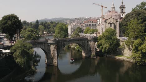 Medieval-stone-bridge-and-castle-in-Amarante-town-of-Portugal,-aerial-view