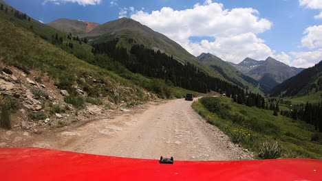 POV-over-the-hood-of-a-4WD-vehicle-traversing-along-a-wide-trail-through-the-Animas-River-Valley-in-San-Juan-Mountains-of-Colorado