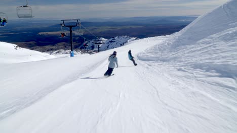 Alpine-skiing-and-snowboarding-on-gentle-slope-at-Mount-Ruapehu,-ski-resort