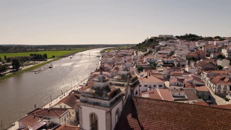 Sado-river-and-picturesque-riverside-Alcacer-do-Sal-cityscape,-Alentejo,-Portugal
