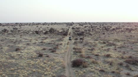 Aerial-View-Of-Tourist-On-A-Safari-At-Namibian-Wilderness-At-Sunset-In-South-Africa