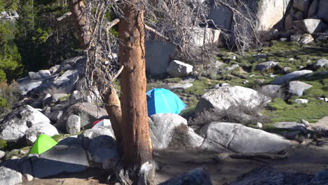Hiking-and-Camping-in-Wilderness,-Tents-Between-Rocks-in-Landscape-of-Mountain-on-Sunny-Day