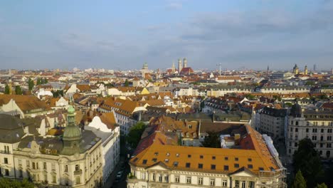 Low-Aerial-Flight-Over-Munich-Buildings-with-Old-Town-in-Background