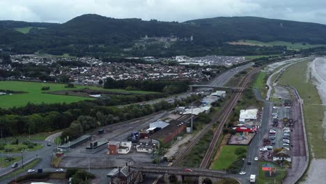 Old-Abergele-Pensarn-seaside-town-North-Wales-mountain-aerial-view-zooming-in-on-A55-expressway