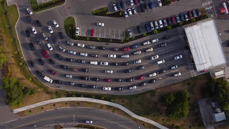 Static-drone-shot-of-cars-and-vehicles-lined-up-at-gas-station-to-buy-fuel-during-pandemic-shortage