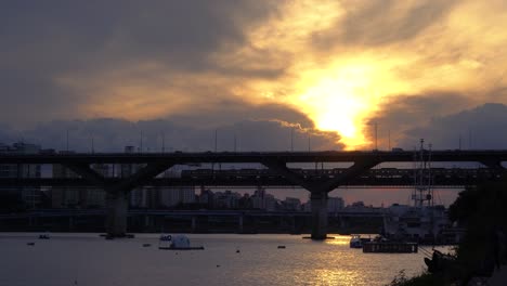 Subway-Train-Silhouette-Moving-Over-Han-River-at-Cheongdam-Bridge-When-Golden-Sun-Goes-Down-to-the-Horizon-at-Sunset-Seoul