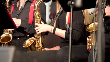 Close-up-of-music-band-in-black-dress-playing-song-with-golden-trumpets