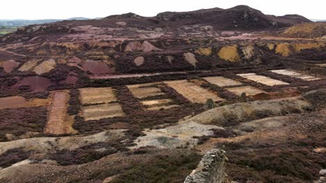 Parys-mountain-rocky-copper-mining-stone-ruin-quarry-aerial-forward-view-Anglesey-mine-Wales-UK