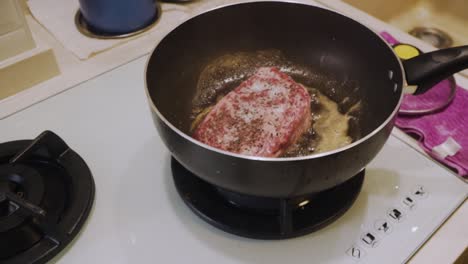 Cooking-A4-Wagyu-Steak-Onto-Hot-Frying-Pan-With-Oil-In-The-Kitchen