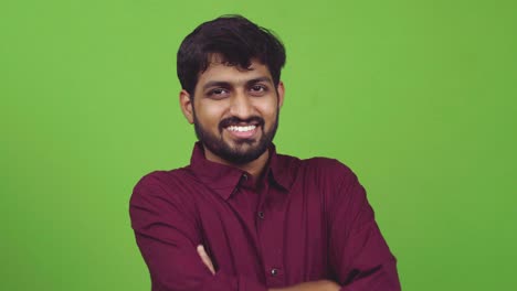 Attractive-and-sexy-Indian-guy-looking-towards-camera-and-smiles,-isolated-on-green-screen