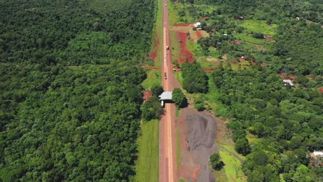 Drone-aerial-footage-revealing-a-large-tropical-highway-crossing-through-a-big-water-reservoir-in-Misiones,-Argentina