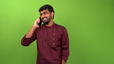 Handsome-man-answering-call-on-smartphone,-isolated-on-green-screen
