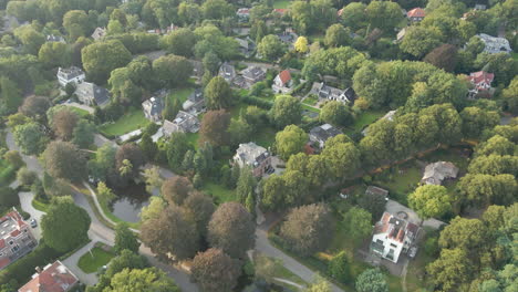 Aerial-tilt-up-and-revealing-wealthy-suburban-neighborhood-with-villas-and-mansions