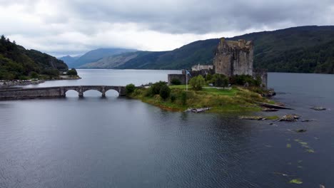 Eilean-Donan-Castle-on-Loch-Long-near-Dornie,-West-Coast-of-Scotland,-Scottish-Highlands---Aerial-Drone-4k-HD-Footage-Fly-Towards
