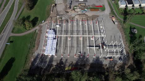 Construction-Site-With-Excavator-and-Crane,-Aerial-Revealing-in-Nordic-Country