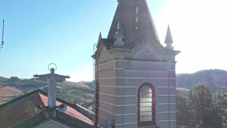 Drone-flying-over-a-church-roof-on-a-sunny-day