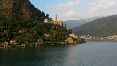 Drone-shot-of-Chiesa-di-Santa-Maria-del-Sasso-in-Switzerland-flying-over-Lugano-lake