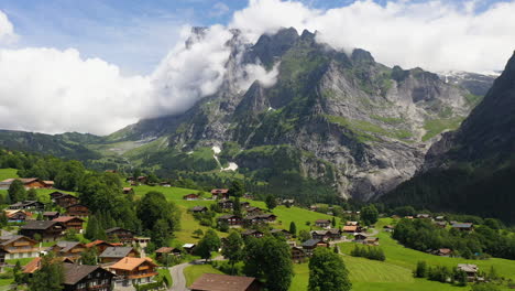 Cinematic-drone-shot-flying-over-buildings-in-Grindelwald,-in-Switzerland’s-Bernese-Alps