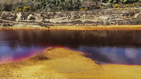 River-of-dark-red-chemicals-from-a-mining-site-in-Cornwall,-England--Wide