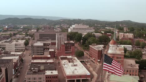 Orbit-of-American-flag-waving-over-downtown-Chattanooga-Tennessee,-USA