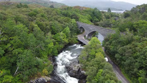 Bridge-over-Morar-River-Waterfall,-West-Coast-of-Scotland---Aerial-Drone-4K-HD-Fly-Towards