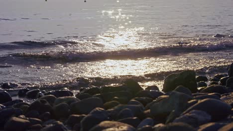 Sun-reflection-at-the-sea-on-a-rocky-beach