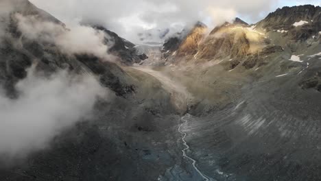 Flyover-through-clouds-towards-Brenay-glacier-in-Valais,-Switzerland
