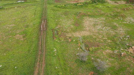 Aerial-footage-of-a-truck-moving-on-dirt-road-near-the-lake,-a-lovely-off-road-scenario,-Muak-Klek,-Saraburi,-Thailand
