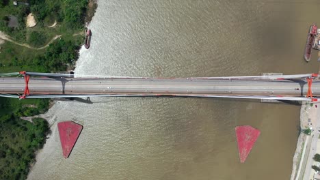 Aerial-drone-vertical-view-of-vehicles-crossing-Zarate-bridge,-in-Argentina