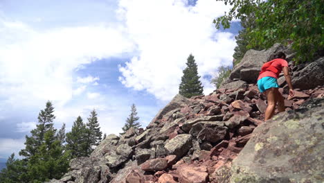 Woman-Walking-Uphill-on-Rocks,-Boulder-Skyline-Traverse-Hiking-Trail,-Colorado,-USA