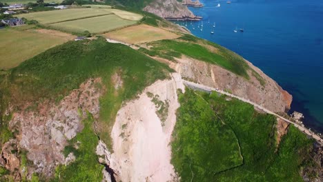 4K-drone-aerial-footage-of-the-island-of-Sark-in-the-Channel-Islands-in-the-southwestern-English-Channel-with-many-sailboats-at-the-background