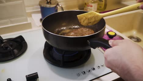Person-Flipping-Over-A4-Wagyu-Steak-Cooking-In-The-Frying-Pan
