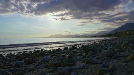 Sunset-at-Playa-de-los-Monteros-on-a-cloudy-day,-Marbella,-Spain