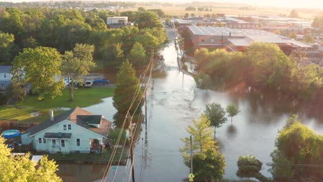 Flood-river-stream-covers-streets-and-roads-in-small-town-America,-USA