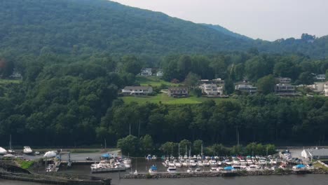 Aerial-drone-video-footage-of-Cornwall-on-Hudson-in-Orange-County-New-York,-in-New-York's-Hudson-Valley-as-seen-from-the-Hudson-River-with-the-Appalachian-Mountains-in-the-background