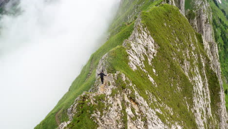 Hiker-walking-on-a-mountain-ridge-in-Switzerland