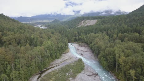 Cloudy-aerial-flight-down-Nusatsum-River-to-green-Bella-Coola-valley