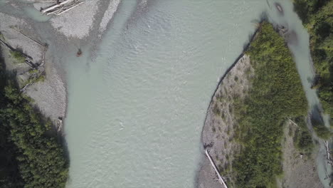 Vertical-river-aerial-tracks-downstream-over-silty-Bella-Coola-river