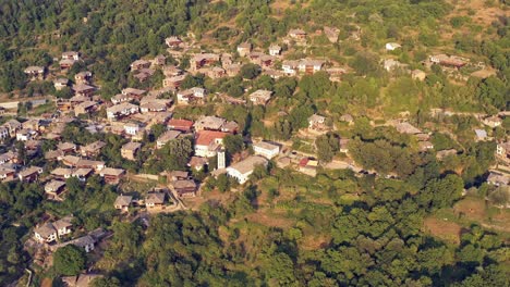 Slow-rising-aerial-shot-of-old-anitque-mountain-village-houses-of-Kovachevitsa-Rhodopes-Bulgaria