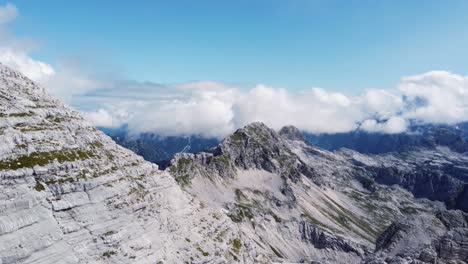AERIAL-Dramatic-Mountainous-Landscape-Reveal-High-Up-in-the-Alps-while-Flying-Close-By-a-Limestone-Peak