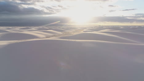 4K-aerial-coming-over-dune-to-reveal-vast-white-sand-dune-field-at-sunrise