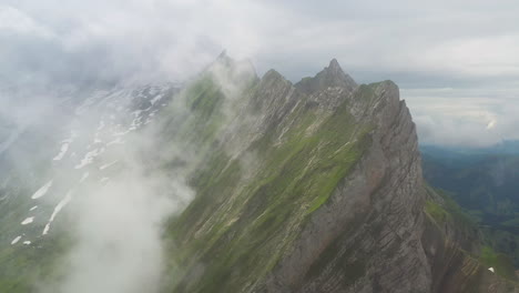 Revealing-drone-shot-starting-in-the-clouds-then-Altenalp-Turm-comes-into-view