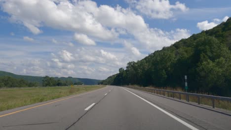 A-view-of-the-highway-while-driving-during-the-daytime-in-the-summer