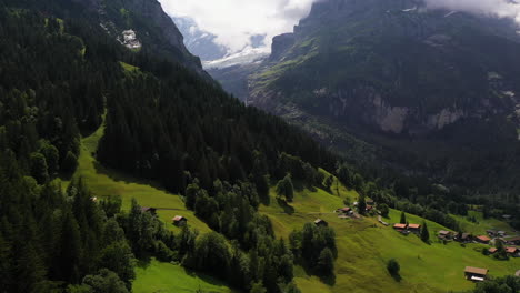 Drone-shot-of-Grindelwald,-a-village-in-Switzerland’s-Bernese-Alps,-with-the-mountains-in-the-background