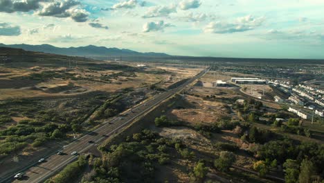 BEAUTIFUL-CLOSE-TO-SUNSET-DRONE-VIEW-FLYING-PARALLEL-TO-REDWOOD-ROAD-IN-BLUFFDALE-UTAH-FACING-NORTH
