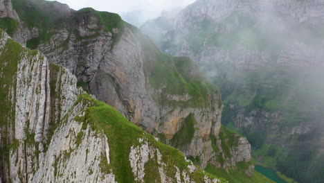 Cinematic-drone-shot-starting-on-a-mountain-ridge-then-revealing-Altenalp-Turm-in-Switzerland