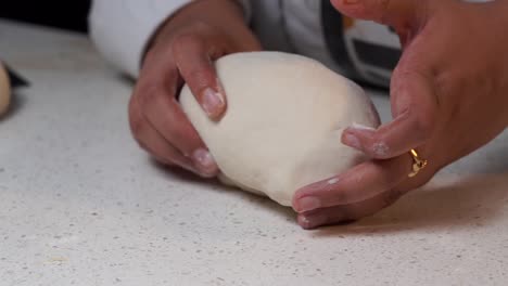 making-the-dough-by-a-hand-closeup-shot
