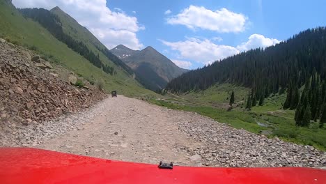 POV-over-red-vehicle-hood-on-narrow-off-road-trail-trail-following-the-Animas-River-Valley-in-San-Juan-Mountains-in-Colorado