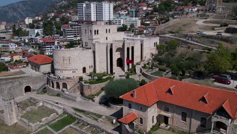 Historic-Museum-of-Skanderbeg-inside-medieval-fortress-with-Kruja-city-buildings-background