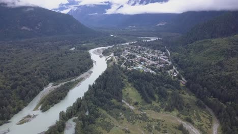 Cloudy-overcast-aerial-flight-up-river-valley-to-town-of-Bella-Coola